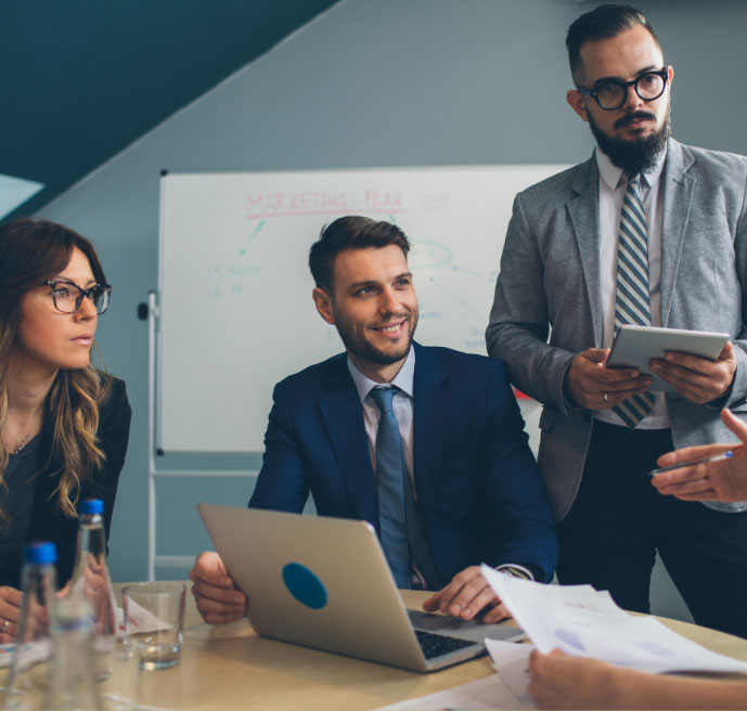 People discussing marketing plan in a boardroom setting.