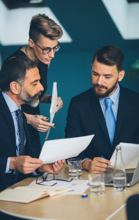Business people looking at a report in a business setting.